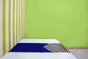 Voodi või voodid majutusasutuse Hotel O Gang Songo Syariah HomestayNearWisata Osing toas