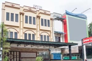 a building on the corner of a street at Capital O 1585 Ring Road Residence in Medan