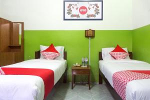 Rúm í herbergi á Super OYO 942 Srikandi Hotel