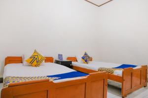 Postel nebo postele na pokoji v ubytování OYO Life 2638 Hotel Raya