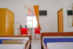 Postel nebo postele na pokoji v ubytování OYO Life 2638 Hotel Raya