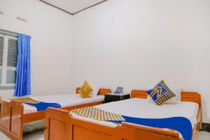 Postel nebo postele na pokoji v ubytování OYO Life 2638 Hotel Raya