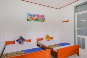 Postel nebo postele na pokoji v ubytování OYO Life 2638 Hotel Raya