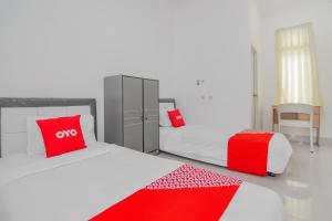 Postel nebo postele na pokoji v ubytování Super OYO Capital O 90342 Kemang Garden