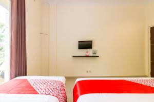 Ein Bett oder Betten in einem Zimmer der Unterkunft OYO 1431 Travel-inn