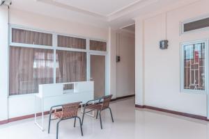 a dining room with two chairs and a table at OYO Life 2658 Kost Rasyamada in Bogor