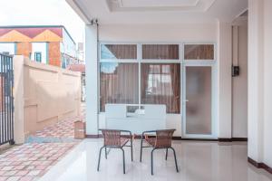 a white table and chairs in a room at OYO Life 2658 Kost Rasyamada in Bogor