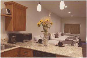 a kitchen with a vase of yellow flowers on a counter at Harbour Inn in Cross Roads