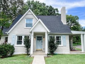 a white house with a blue door at Adorable 1BR Apt. w KING bed 1 m. to square in Columbia