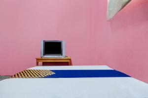 a bedroom with a bed and a computer on a table at OYO 90268 Aliyah Syariah in Jakarta
