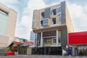 an apartment building in the middle of the street at OYO Life 1830 Mandala Residence in Jakarta +12 photos