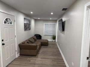 a living room with a couch and a chair at The Family Retreat in Calumet City +13 photos