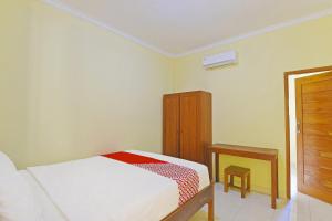 Postel nebo postele na pokoji v ubytování OYO Life 90675 Ld Residence