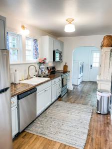a kitchen with white cabinets and a sink at Cozy 2BR Apt w KING in historic dist. 1mi to sq. in Columbia