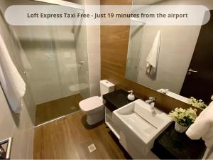 a bathroom with a sink and a toilet and a mirror at Posada Express Confort Check-In & Free Airport Taxi in Isla del Mono