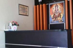 a counter with a picture of a man on a wall at Hotel O Lembah Sriti Homestay Near Sirkuit Motor Cross Internasional 459 Lantan in Labuan Lombok