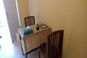 a table with a table and two chairs and a table with a tableablish at Hotel O Kelimutu Eco VillageNearMurundao Waterfall in Kelimutu +11 photos