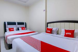 Ein Bett oder Betten in einem Zimmer der Unterkunft OYO 3334 Ratu Residence