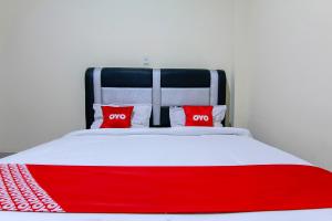Ein Bett oder Betten in einem Zimmer der Unterkunft OYO 3334 Ratu Residence