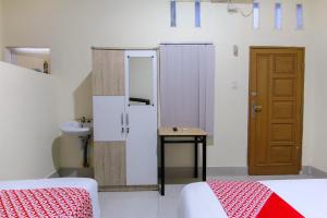 Ein Bett oder Betten in einem Zimmer der Unterkunft OYO 3334 Ratu Residence