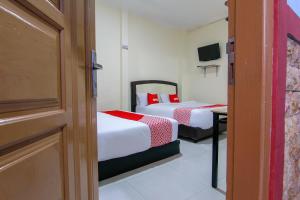 Ein Bett oder Betten in einem Zimmer der Unterkunft OYO 3334 Ratu Residence