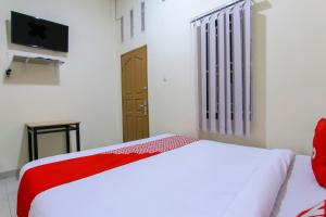 Ein Bett oder Betten in einem Zimmer der Unterkunft OYO 3334 Ratu Residence