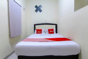 Ein Bett oder Betten in einem Zimmer der Unterkunft OYO 3334 Ratu Residence