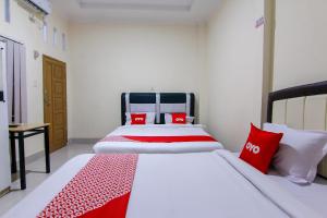 Ein Bett oder Betten in einem Zimmer der Unterkunft OYO 3334 Ratu Residence