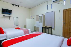 Ein Bett oder Betten in einem Zimmer der Unterkunft OYO 3334 Ratu Residence