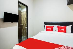 Postel nebo postele na pokoji v ubytování OYO 3826 Columbus Residence K11