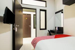 Postel nebo postele na pokoji v ubytování OYO 3826 Columbus Residence K11 + 21 fotografií