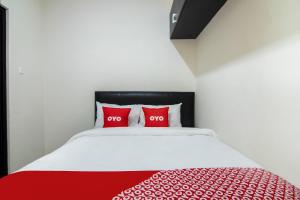 Postel nebo postele na pokoji v ubytování OYO 3826 Columbus Residence K11