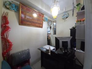 an office with a desk and a computer on a wall at OYO Life 93023 Kost Bulan Karawang in Karawang