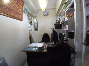 an office with a desk with a computer on it at OYO Life 93023 Kost Bulan Karawang in Karawang