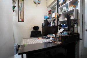 an office with a desk with a chair in a room at OYO Life 93023 Kost Bulan Karawang in Karawang +10 photos