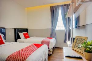 Postel nebo postele na pokoji v ubytování SUPER OYO 93064 Alhesa Residence