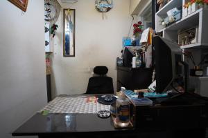 a desk with a computer on top of it at OYO Life 93023 Kost Bulan Karawang in Karawang