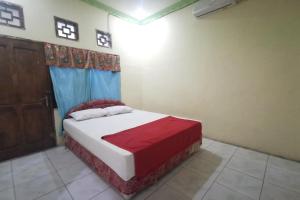 Ένα ή περισσότερα κρεβάτια σε δωμάτιο στο Hotel O Widan Homestay