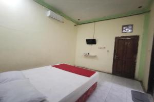 Ένα ή περισσότερα κρεβάτια σε δωμάτιο στο Hotel O Widan Homestay