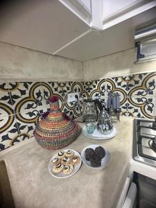 una encimera con platos de galletas y un jarrón en Mini Style Riad in the heart of the Medina, en Essaouira 9 fotos más