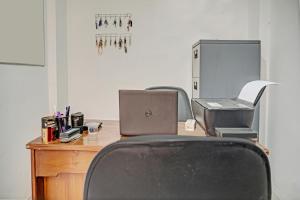 an office with a desk with a laptop and a chair at Hotel O Kusuma Residence Syariah in Palembang