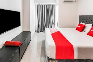 a bedroom with a large bed with red pillows at Fortune 88 Kamala Lagoon Reception at Indomaret and White Forest in Bekasi