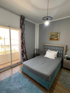 sypialnia z łóżkiem i dużym oknem w obiekcie Étage privé tout confort deux chambres salle de bain et espace cuisine dappoint w mieście Arjana