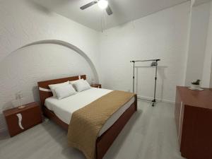 a bedroom with a bed and a ceiling fan at Casa da Praça II in Vila Nova