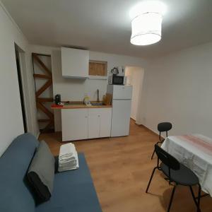 a kitchen and a living room with a couch and a table at Chiado Carmo Sunny Lodge in Lisbon