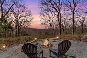 two chairs sitting around a fire pit with a sunset at 5 Mi to Beaver Lake Family Cabin with Game Room in Eureka Springs
