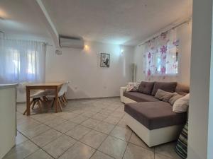 a living room with a couch and a table at Apartment Zavala 8774b in Jelsa