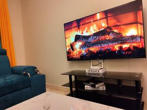 RungiriにあるGoodlife Apartmentの暖炉とテレビのあるリビングルーム