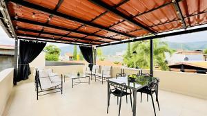 a dining room with a table and chairs on a balcony at Ajijic 1 Bedroom Guesthouse -Walk To Everything -Patio -Bikes - Pickleball Court in Ajijic