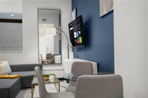 a living room with a couch and a table at CozySuites Modern 1BR in Downtown Pitts 7 in Pittsburgh